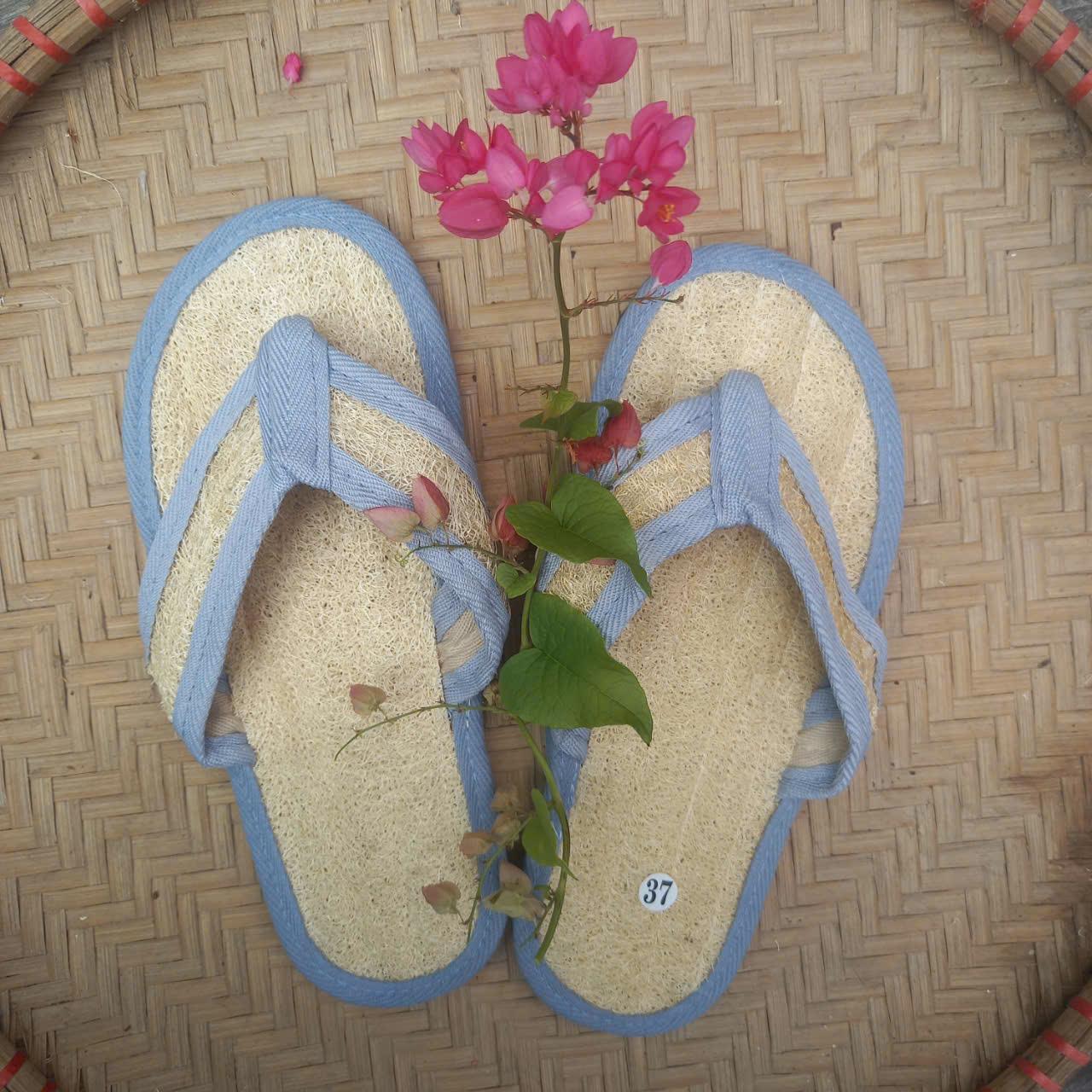 Wholesale natural loofah slippers with textured insoles for spa and hotel use.